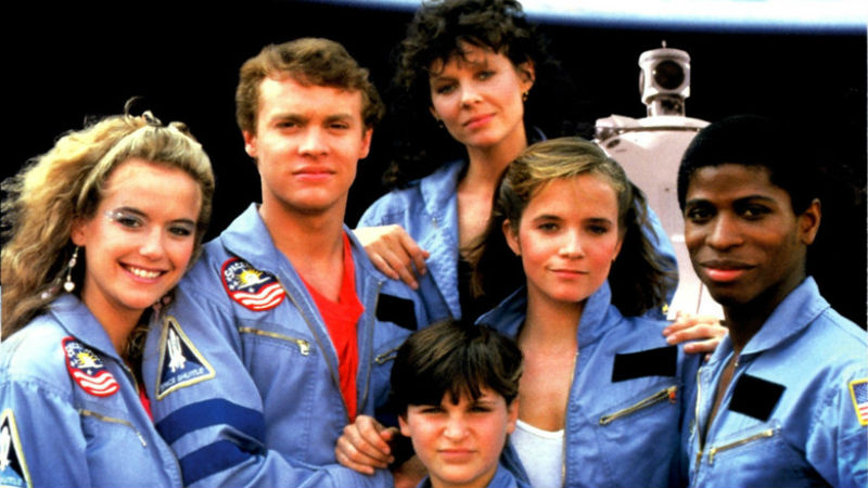 The cast of Space Camp is pretty crazy: Yes, that’s Kelly Preston, Tate Donovan, and Lea Thompson along with Joaquin Phoenix, Kate Capshaw, and Larry B. Scott.